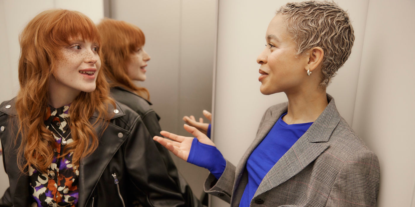 Two women having a conversation in an elevator - KONE Modernization